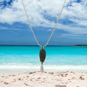 Beach rock drilled pendant with a beautiful freshwater pearl accent.